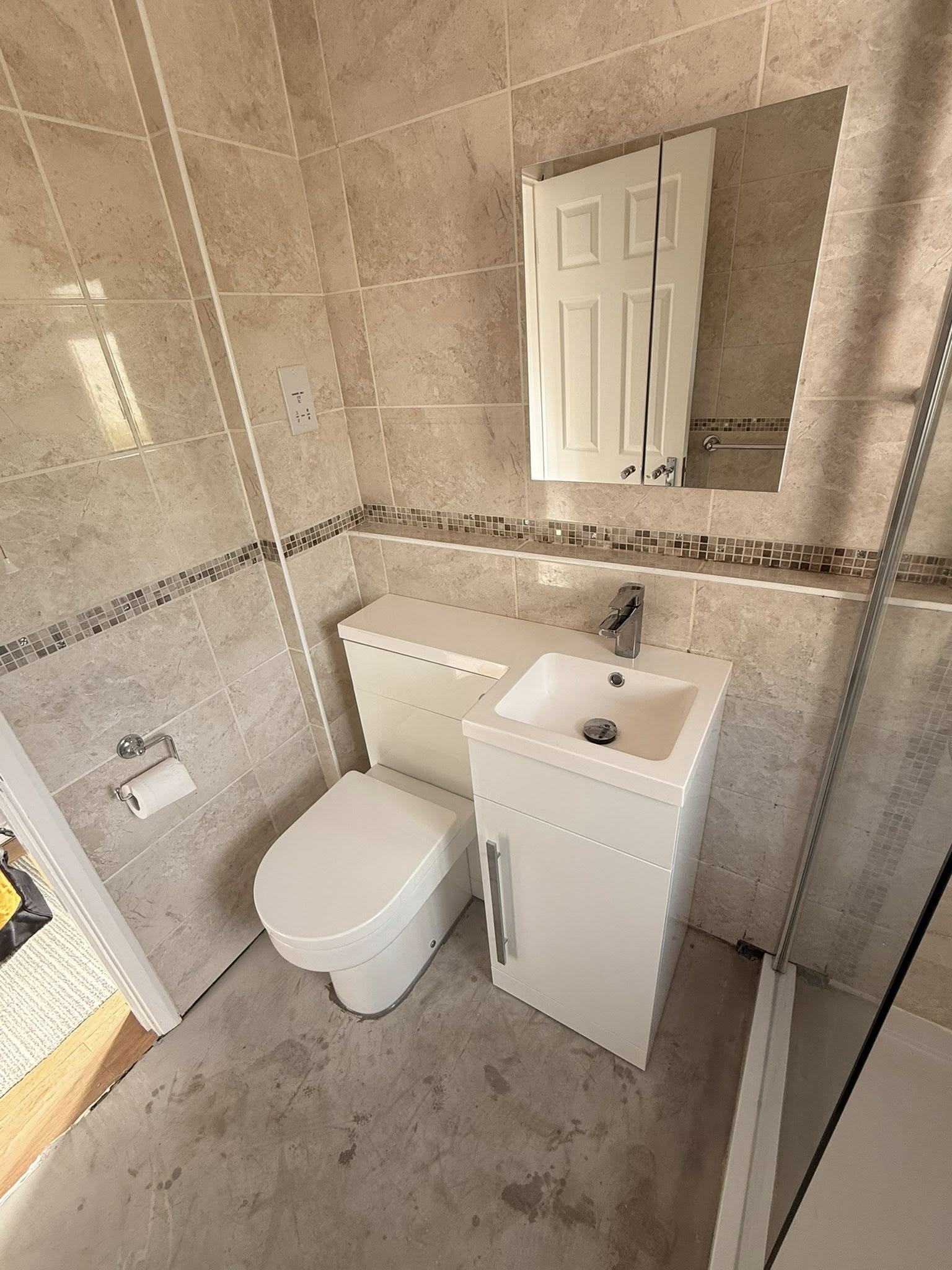 Tiled bathroom with shower enclosure and vanity unit