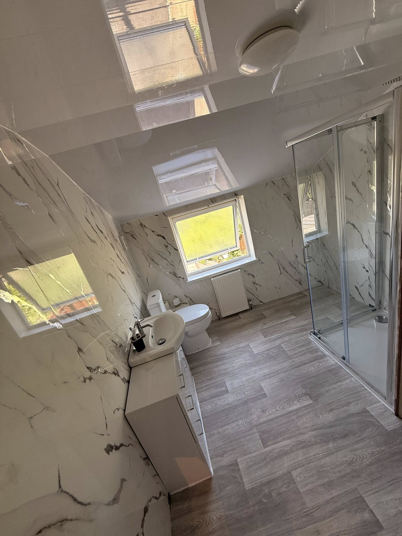 Loft bathroom with marble tiles and walk-in shower